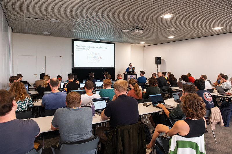 A group of people looking at a projector screen in a classroom